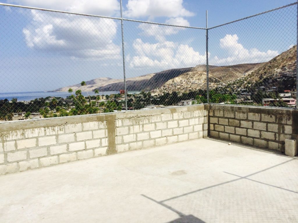 See that there fence? Our students had no place to play during recess and there was no more space to build on the school property. So Eric had this idea to put a fenced in area on the roof of the second story! Jon is an engineer and headed up this endeavor. Now the kids have a place to play! We are still hoping to purchase an expensive net to cover the top so that the basketball goals can be installed in the near future!